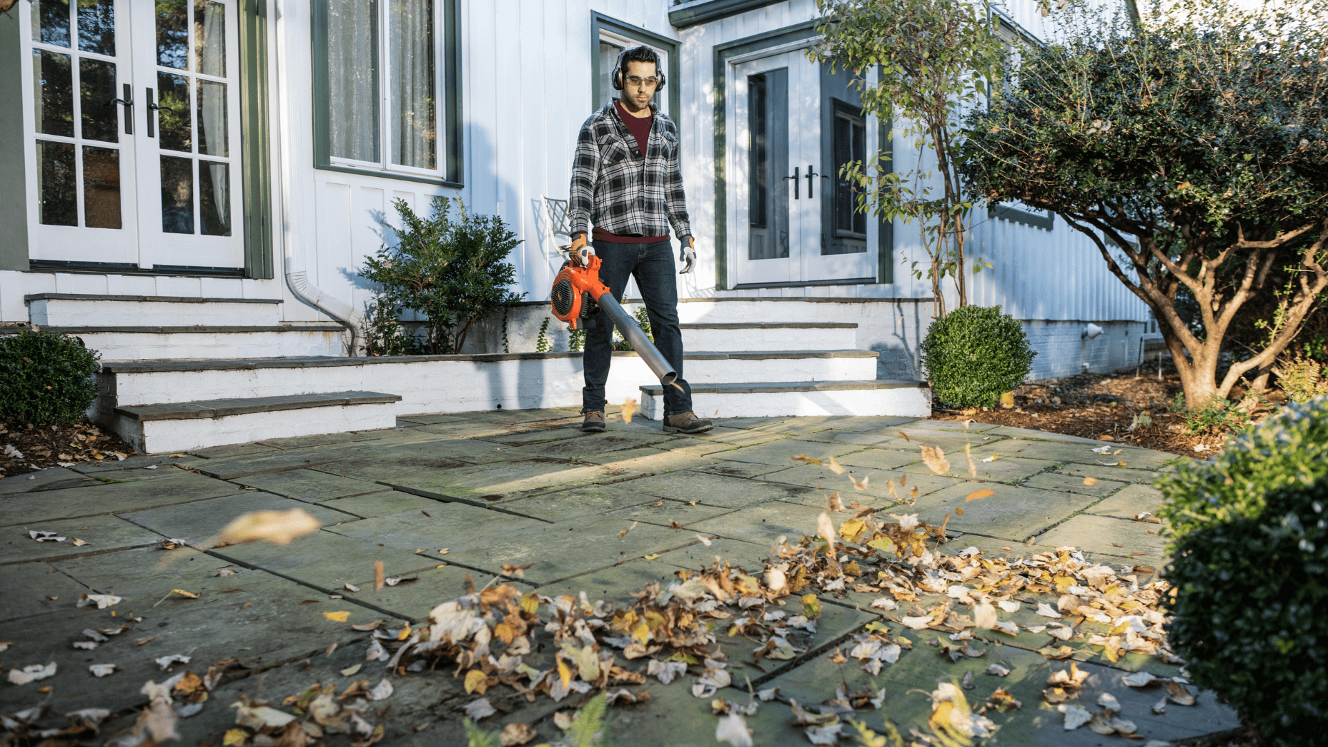 man with leafblower in courtyard
